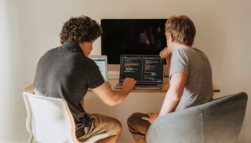  two men working at desk