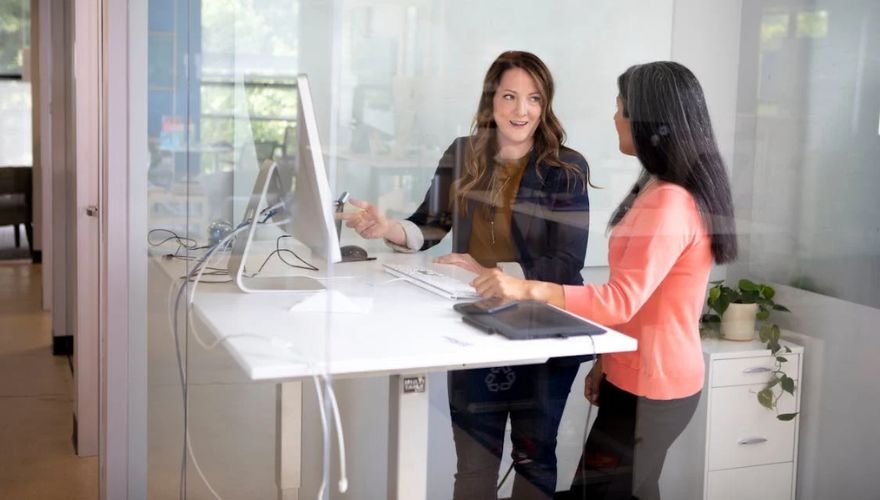 two women at a standing desk