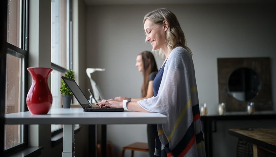 woman using a standing desk at work